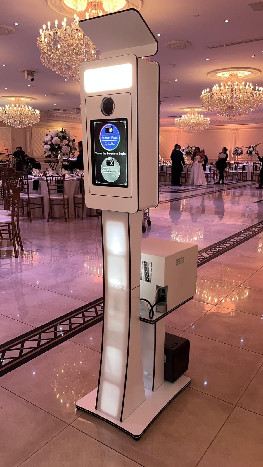 Glam photobooth kiosk in a chandelier-lit ballroom
