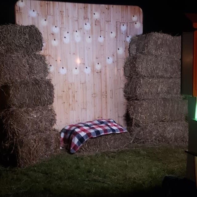 Rustic hay bale photobooth backdrop with string lights