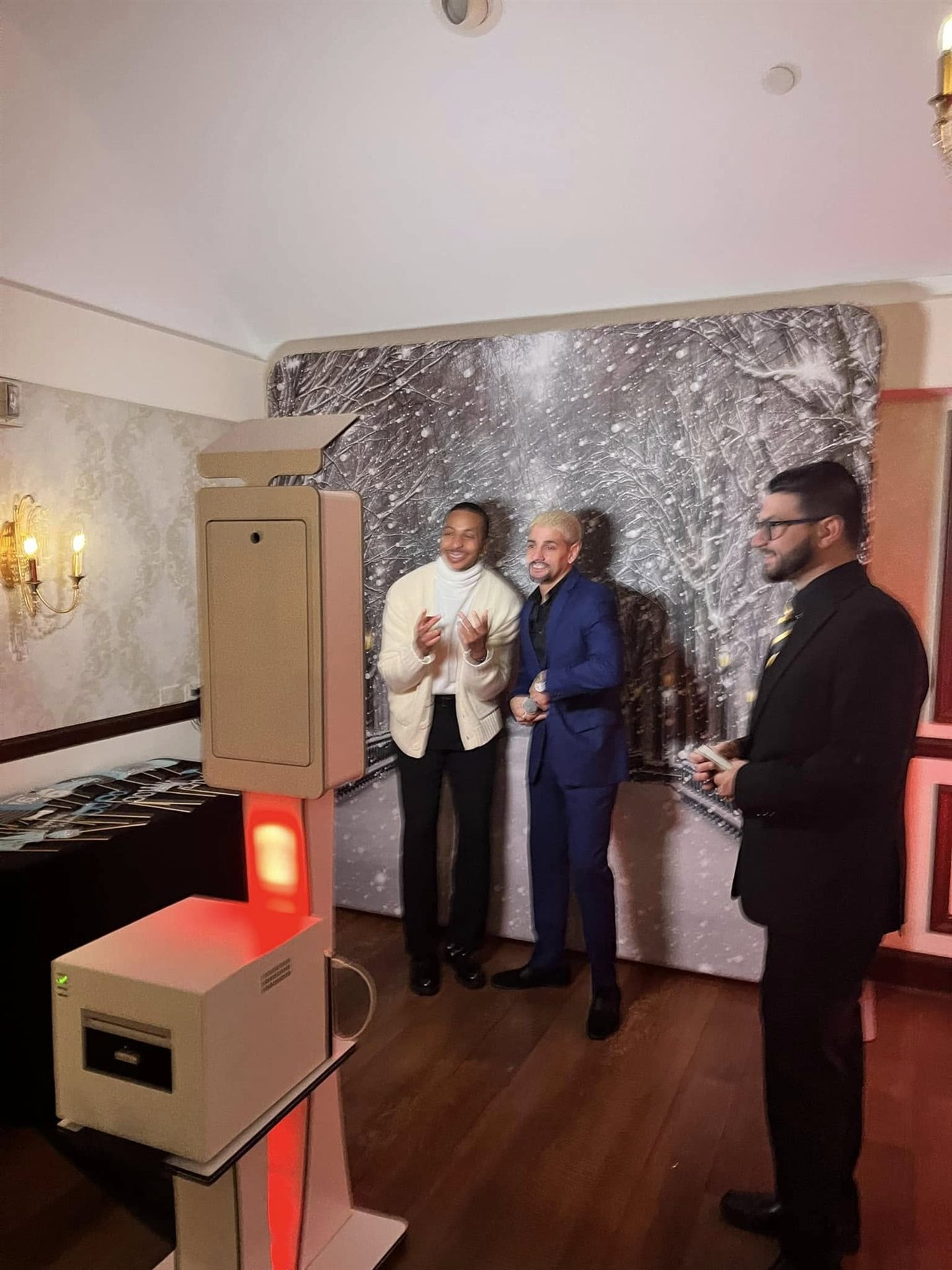 Guests posing at a winter-themed photobooth backdrop
